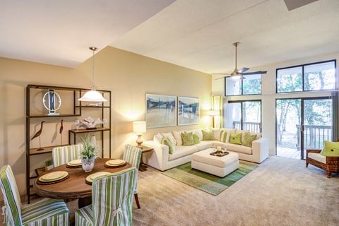 a living room with a couch and a table and chairs